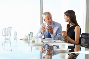 Business man and woman meeting at a conference table